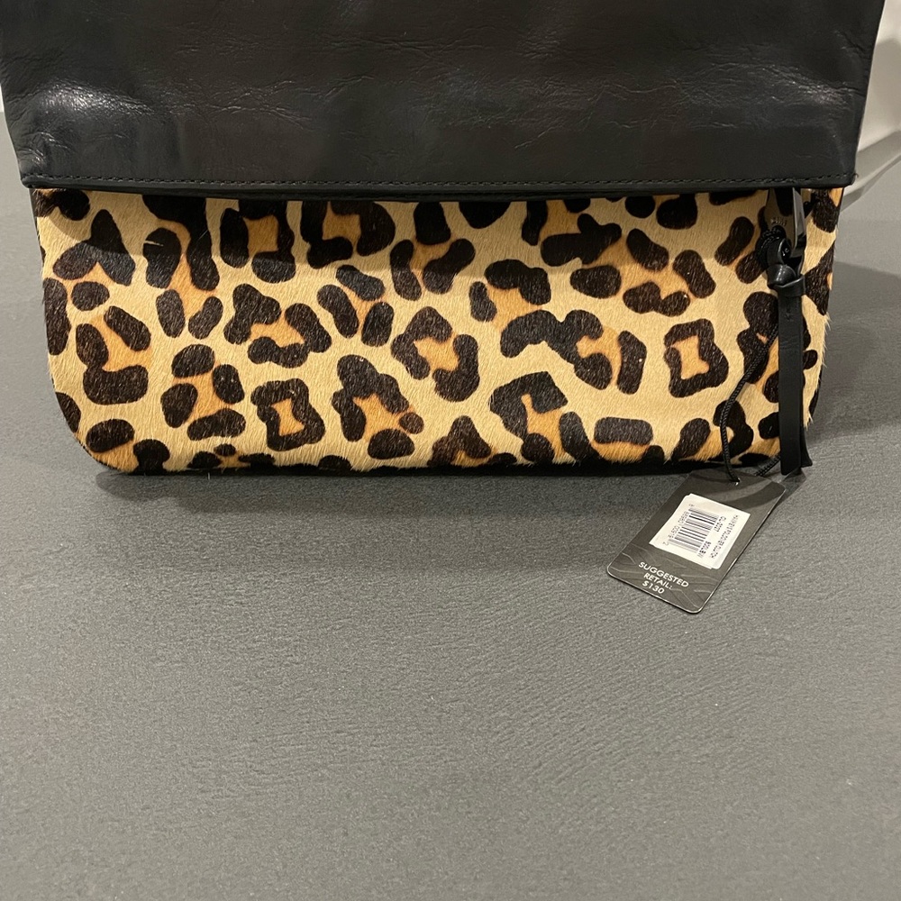 Clutch zippers and folds over
